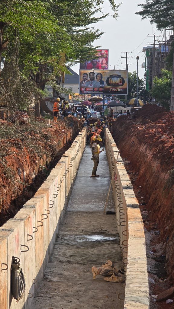 Precast base concrete cast for the 1.5 m × 1.625 m (varies) open channel drain on the left-hand side along Summit Road, Asaba, at CH 0+150.