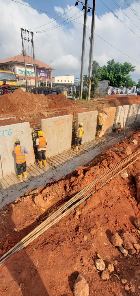 Placing of surface drain pre-cast wall at CH 0+315
